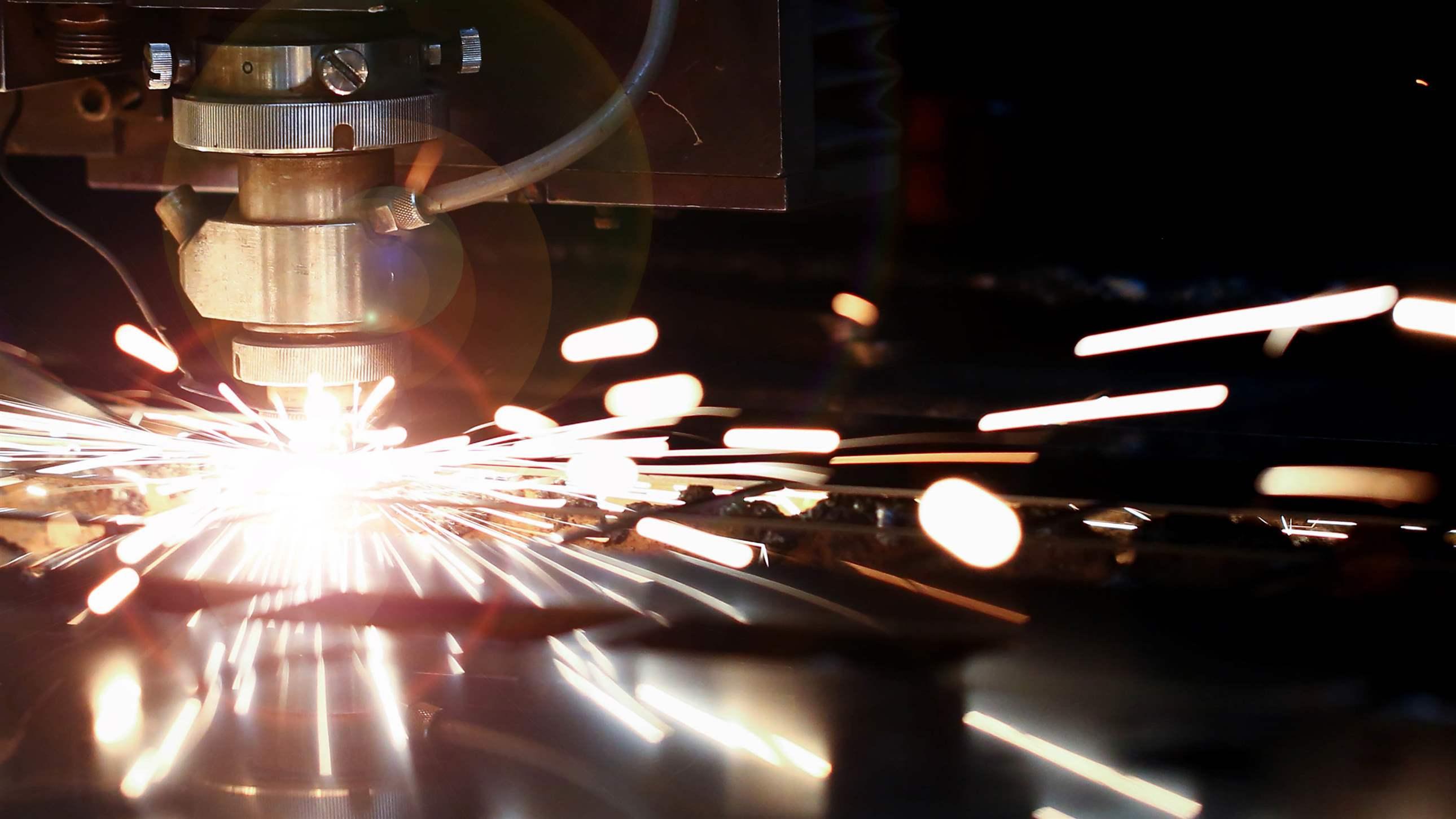 Laser metall cut cnc machine. Fly fire sparks background. Industrial processing concept